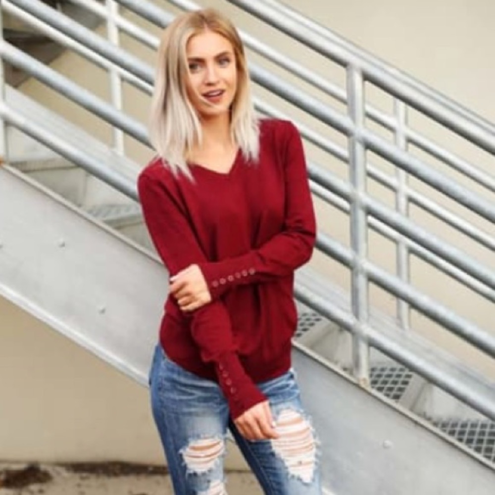 V neck sweater with button accents on wrists